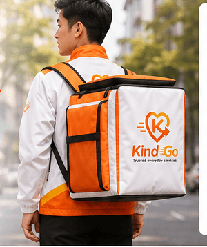 KindGo runner carrying a large orange and white delivery backpack on a tree-lined street