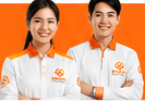 Two smiling KindGo providers in uniform with arms crossed